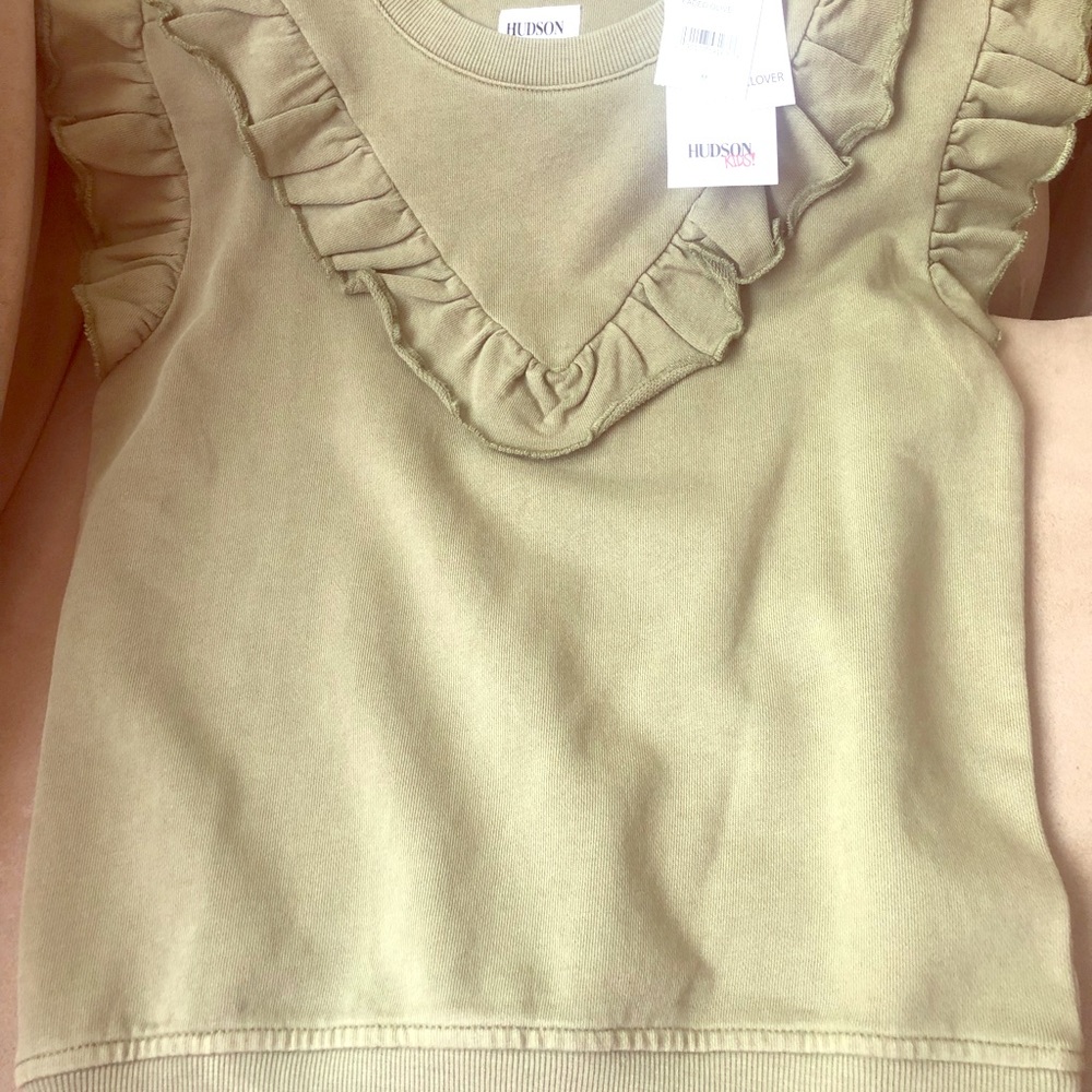 Girl’s size Med. ruffle pullover. Brand new